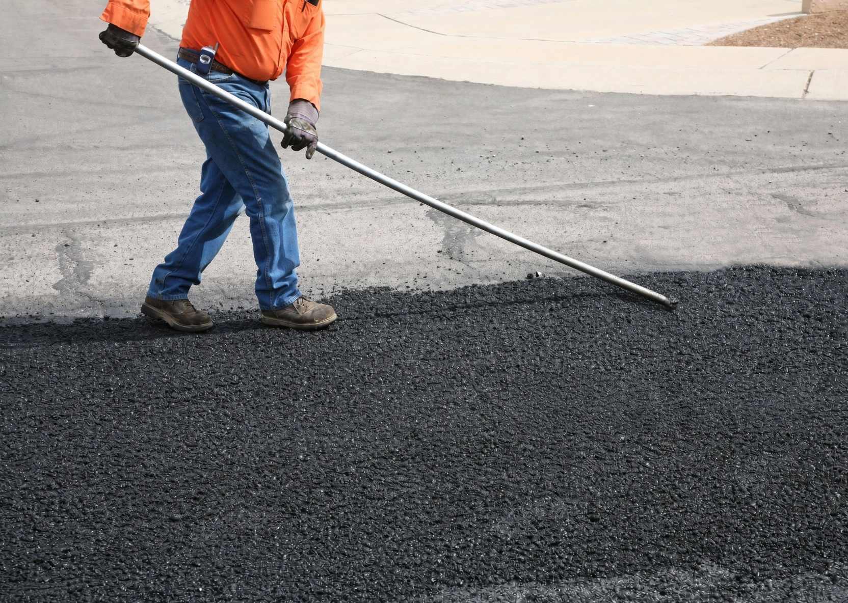 Asphalt paving crew laying hot mix on a Knoxville TN driveway