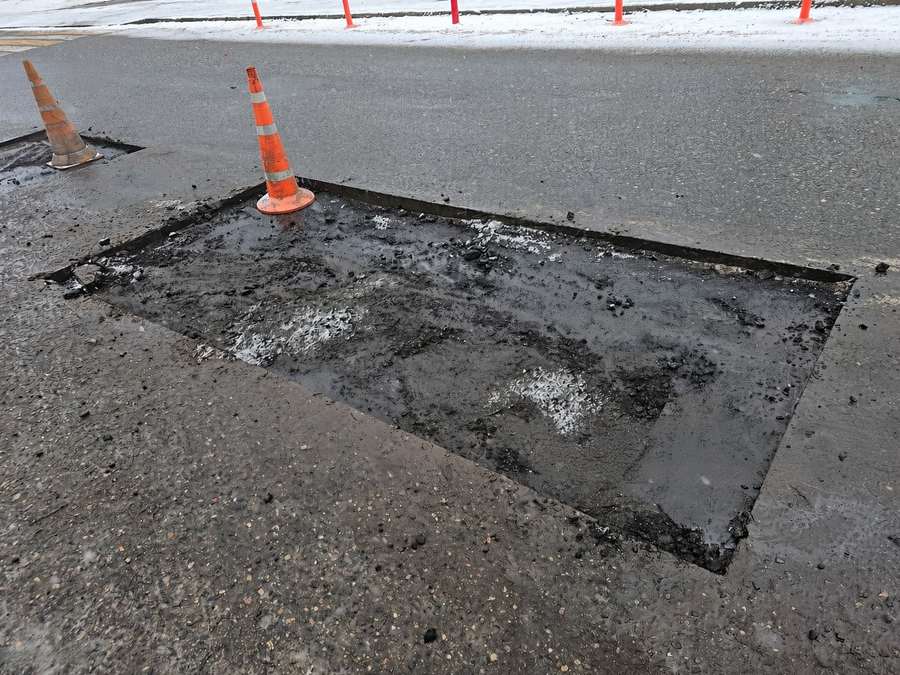 Dumpster pad asphalt failure about to be repaired in a Knoxville commercial lot