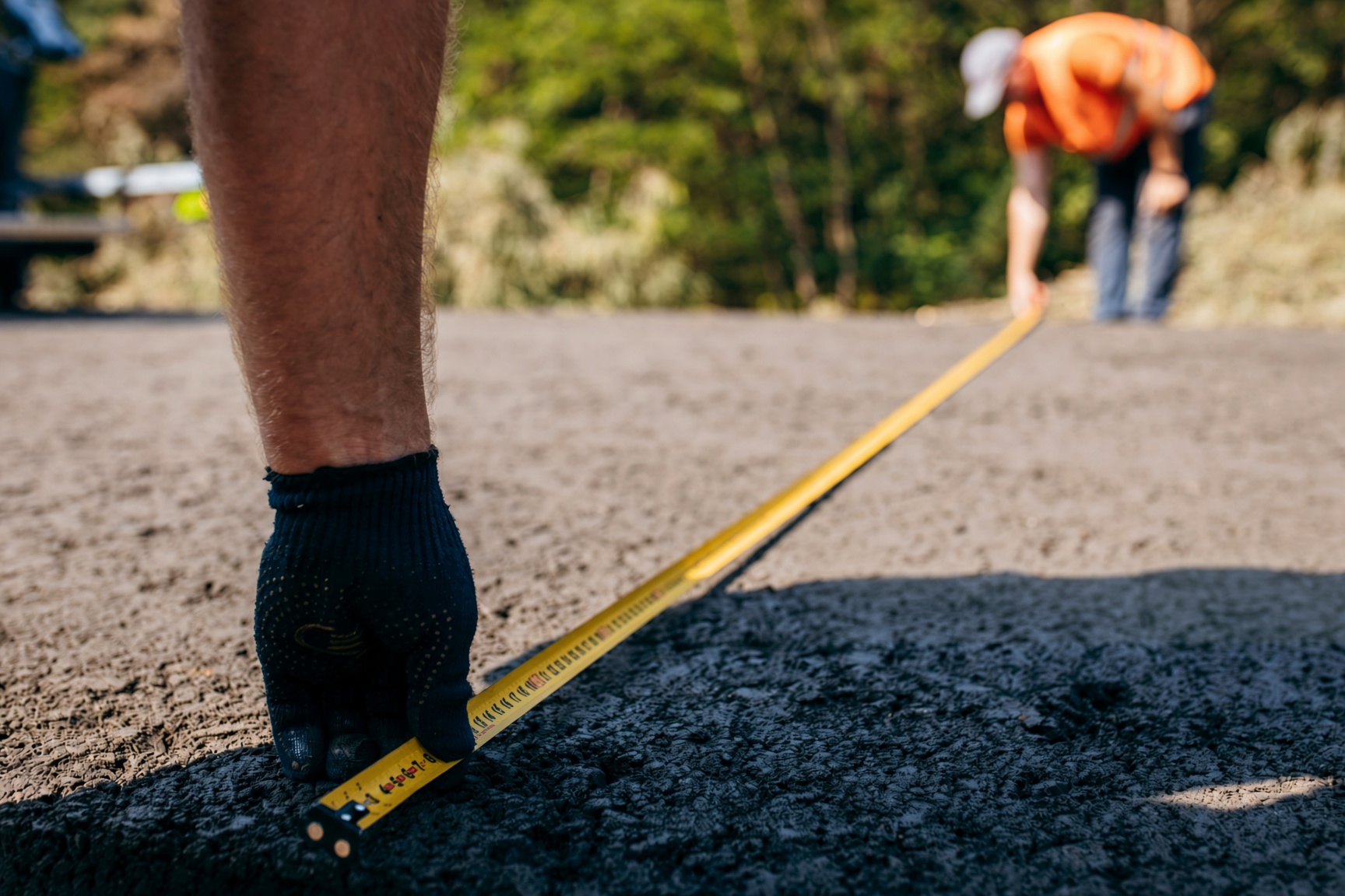 Estimator measuring a driveway for asphalt paving in Knoxville TN