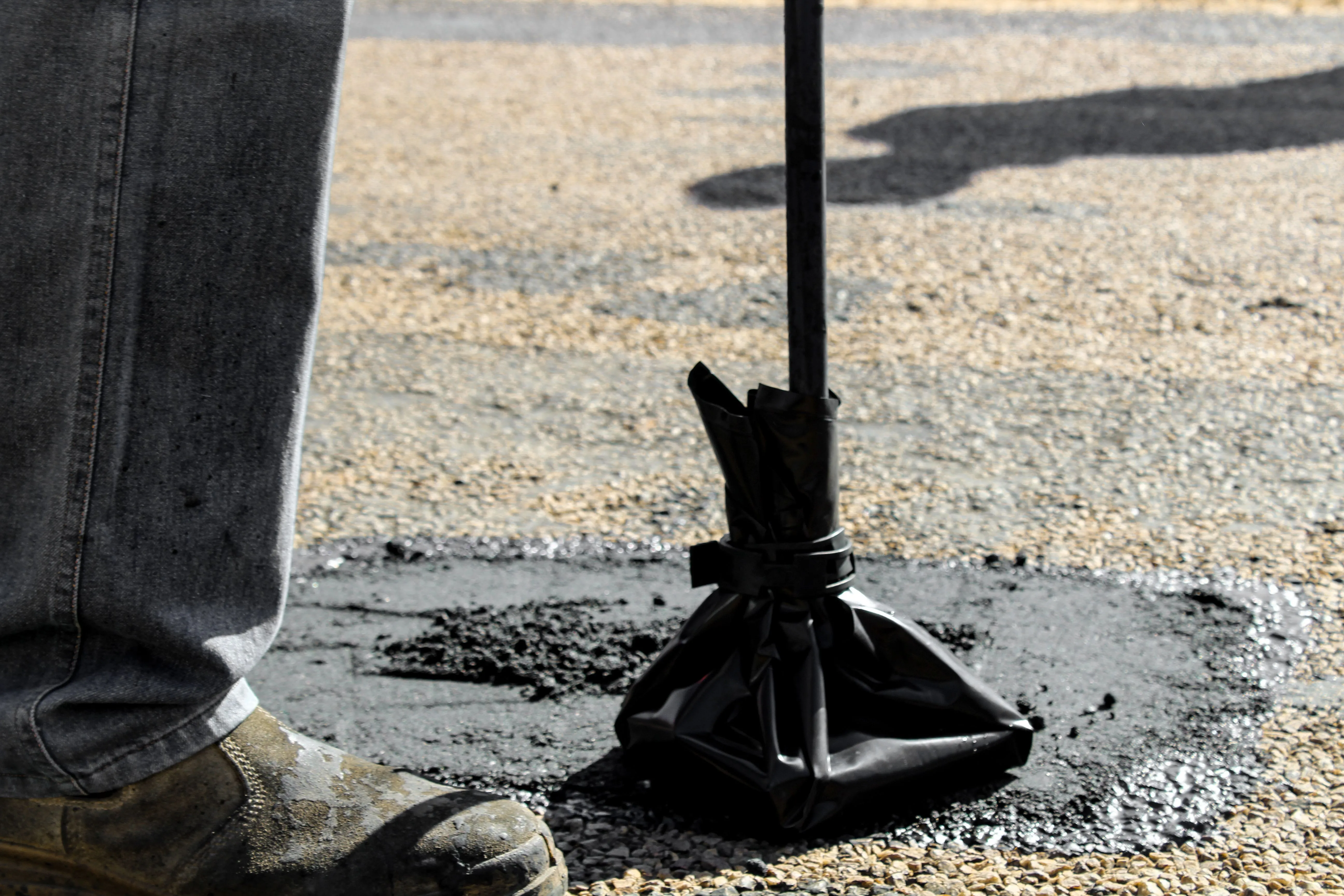 Pothole being patched with hot mix asphalt in a Knoxville parking lot